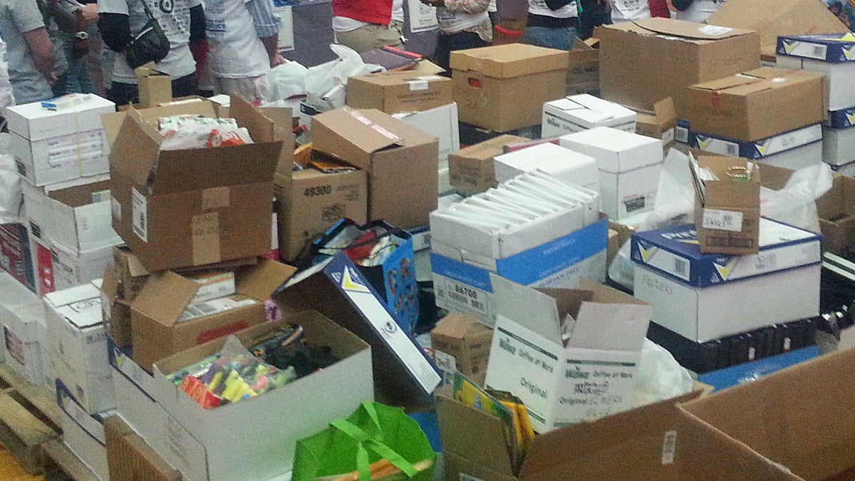 Donated school supplies pile up inside Girard College at an MLK Day of Service event. (Tom MacDonald/WHYY)
