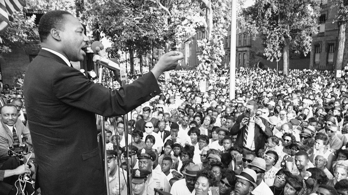 Dr. Martin Luther King is shown speaking at a amass meeting in front of all-white Girard College in Philadelphia on  August 4