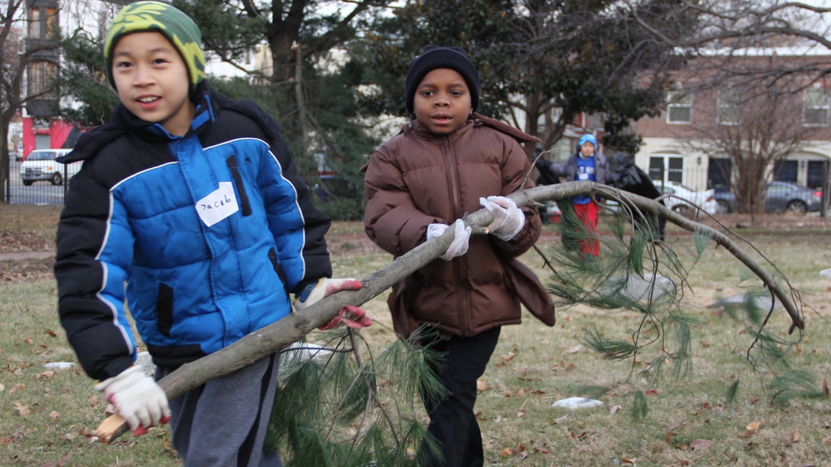  Jacob Louie, 9, and Ibrahim Carroll, 6, help to clean up Fair Hill Burial Ground. (Emma Lee/for NewsWorks) 