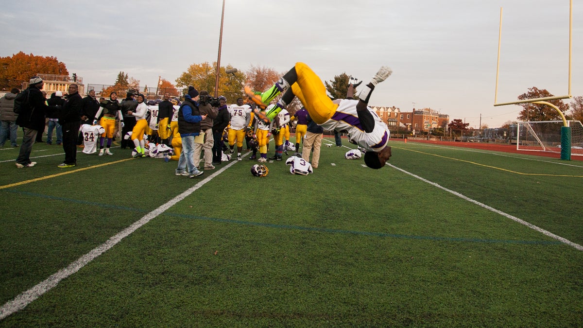  Raheim Page of the MLK Cougars does a backflip in celebration of the team's Public League Class AAA championship win on Saturday. (Brad Larrison/for NewsWorks) 