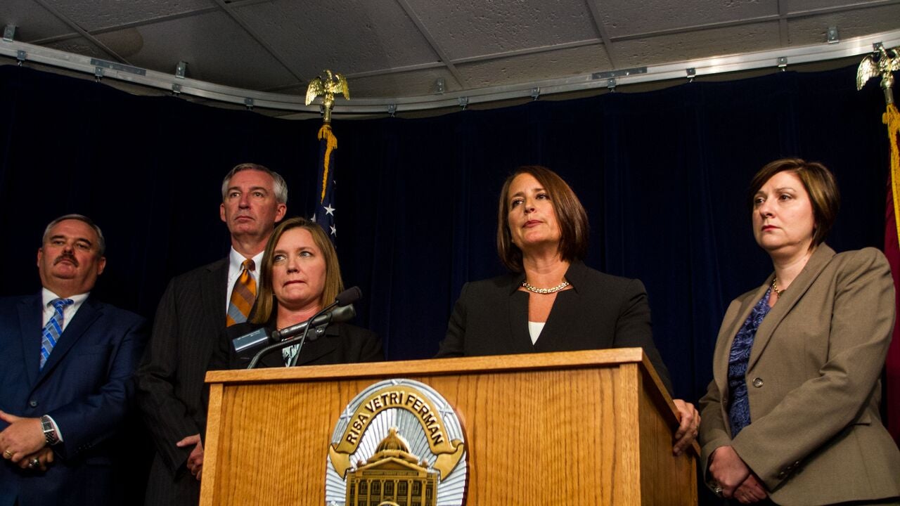  Montgomery County District Attorney Risa Vetri Ferman, center, announces charges Thursday against Pennsylvania Attorney General Kathleen Kane. She is surrounded by prosecutors from Bucks and Montgomery counties who took part in the investigation leading to the charges.(Brad Larrison/for NewsWorks) 