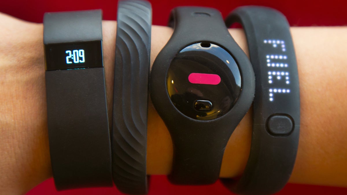 Four fitness trackers from left to right