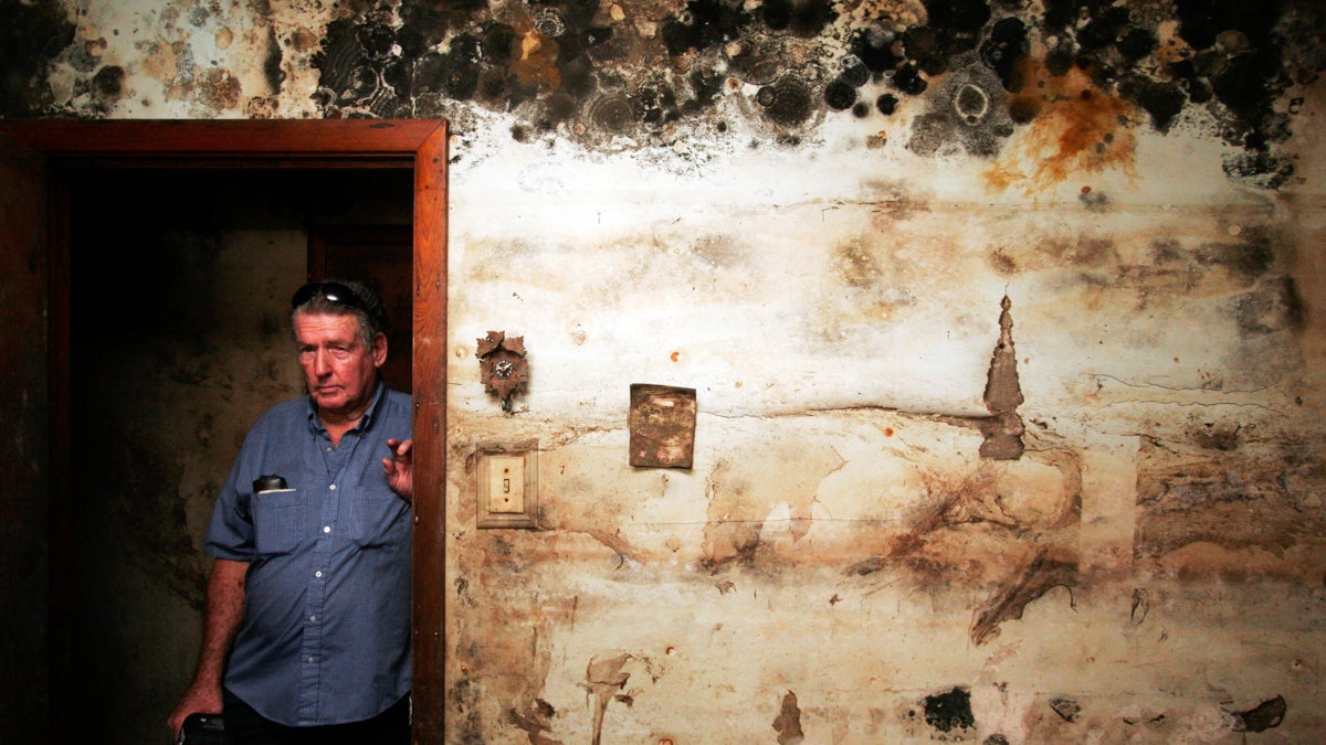 Joe Middleton poses for a photograph in his still yet-to-be gutted home