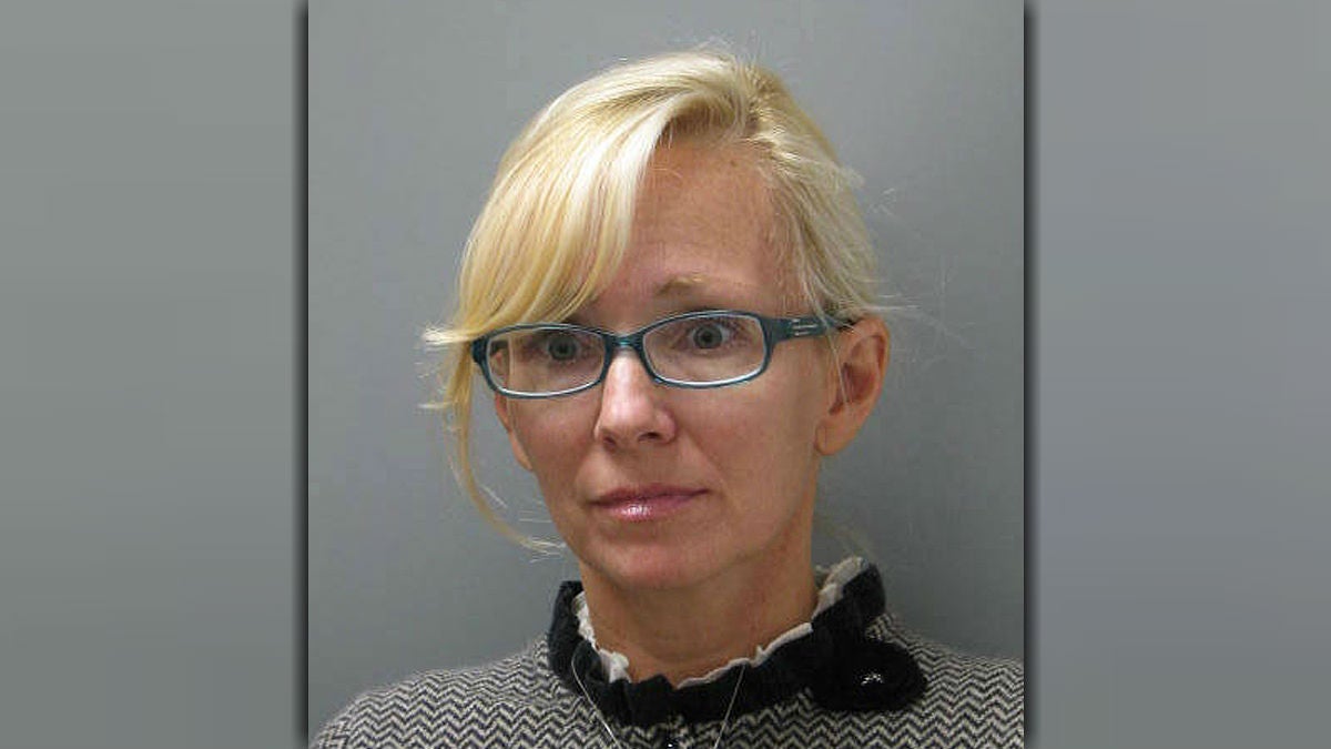  In this undated photo provided Wednesday, Nov. 5, 2014 by the Delaware State Police, Molly Shattuck, of Baltimore, poses for a police mug shot. Shattuck, 47, a former Baltimore Ravens cheerleader and the estranged wife of a prominent Maryland energy executive has been arrested and charged in connection with a sexual relationship involving a 15-year-old boy. Shattuck was indicted Monday, Nov. 3, 2014, on two counts of third-degree rape, four counts of unlawful sexual contact and three counts of providing alcohol to minors. (AP Photo/Delaware State Police) 