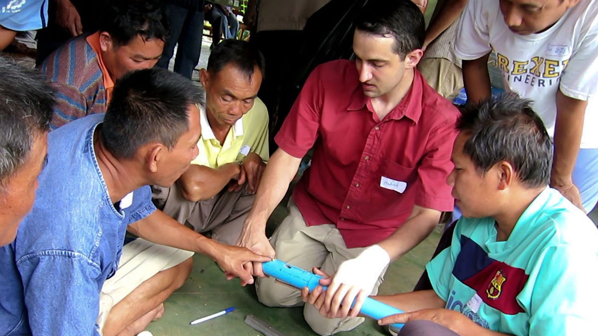  A group of self-taught mechanics in remote Bo Kluea, Thailand, brainstorm design improvements for a labor-saving seed planter with Drexel University's Alexander Moseson. (Image courtesy of Drexel University) 