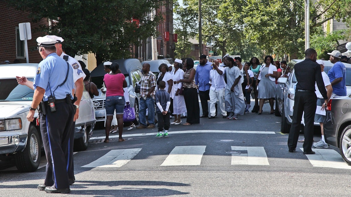  Mourners arrive at the Seventh-Day Adventist Church at 15th and Oxford streets in North Philadelphia on Monday morning for funeral services for the three children killed in a hit-and-run tragedy on July 25. (Kimberly Paynter/WHYY) 