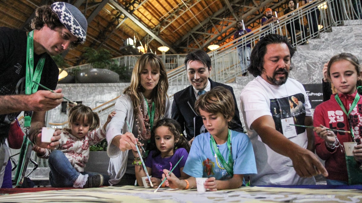  The Walker family joins artist Cesar Viveros for the breaking of the world record at the Pennsylvania Convention Center. (Kimberly Paynter/WHYY) 