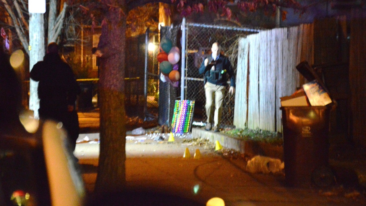 Wilmington Police search for clues Monday night after a city man was killed in front of a memorial to a shooting victim who was killed Friday night. (John Jankowksi/for NewsWorks)