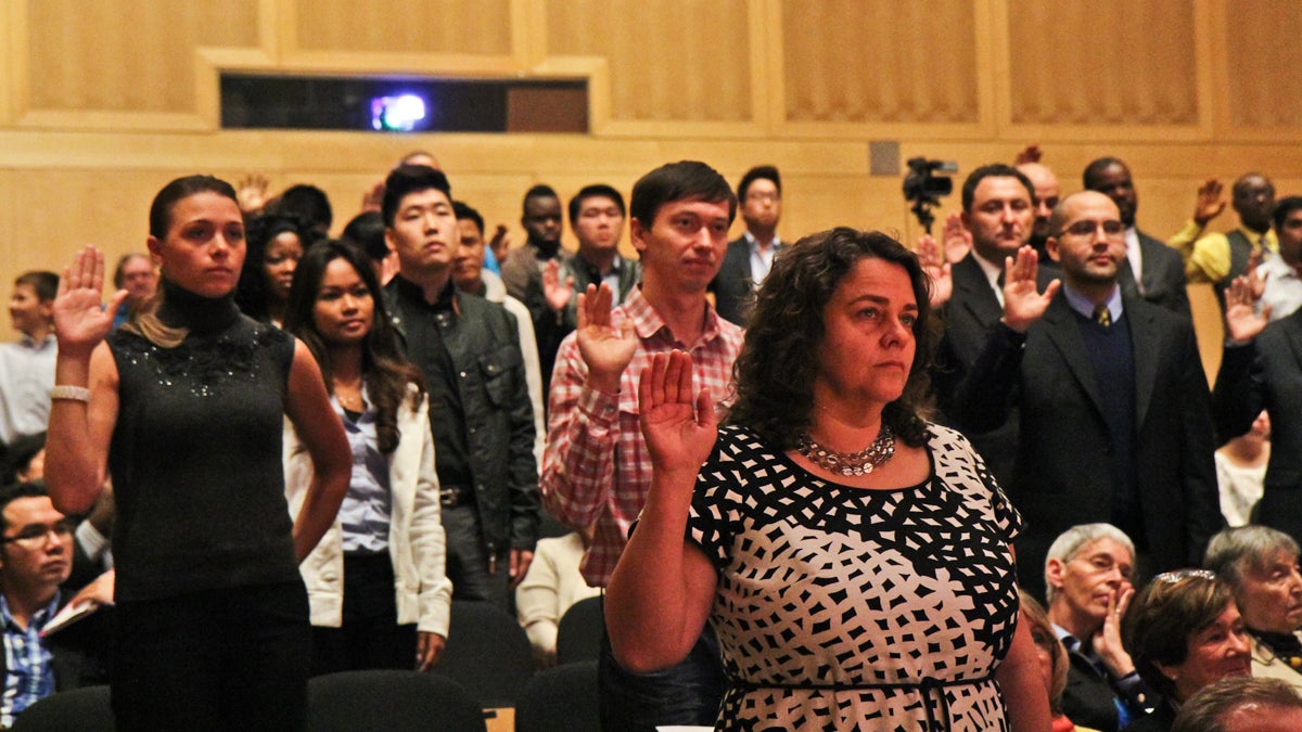  More than 50 new citizens from 27 countries take the Oath of Citizenship at the U.S. District Court for the Eastern District of Pa. 2013 Naturalization Ceremony. (Kimberly Paynter/WHYY) 