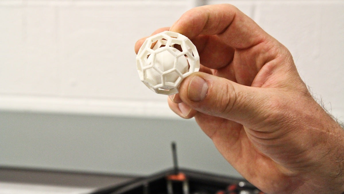  The 'build from the ground up' nature of 3-D printing allows for the sphere to be printed inside the shape in one step. (Kimberly Paynter/WHYY) 