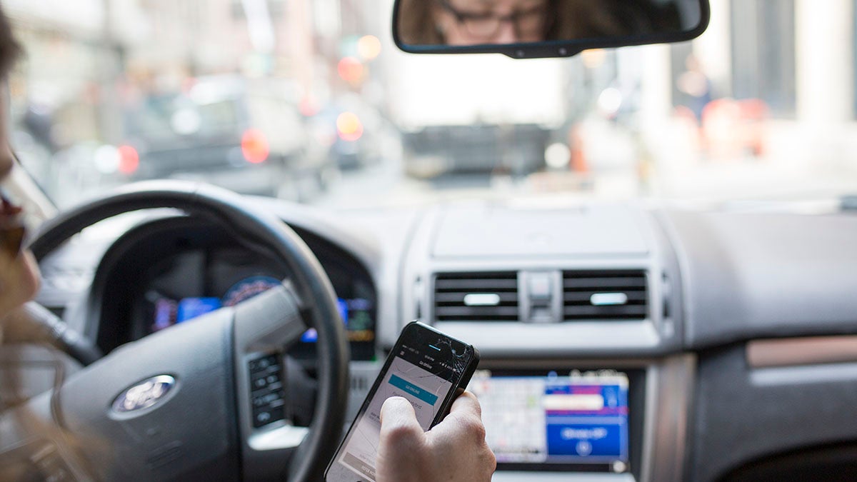 A Philadelphia UBER driver consults her phone during her shift. (Jessica Kourkounis for Keystone Crossroads)