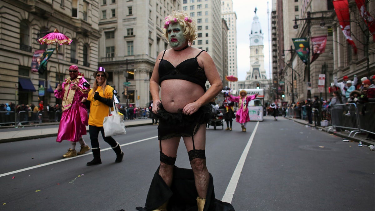  Comic club member Michael Kenney celebrates the New Year on South Broad Street and adjusts his costume during the 116th annual Mummers Parade in Philadelphia on Friday, Jan. 1, 2016. (AP Photo/Joseph Kaczmarek) 