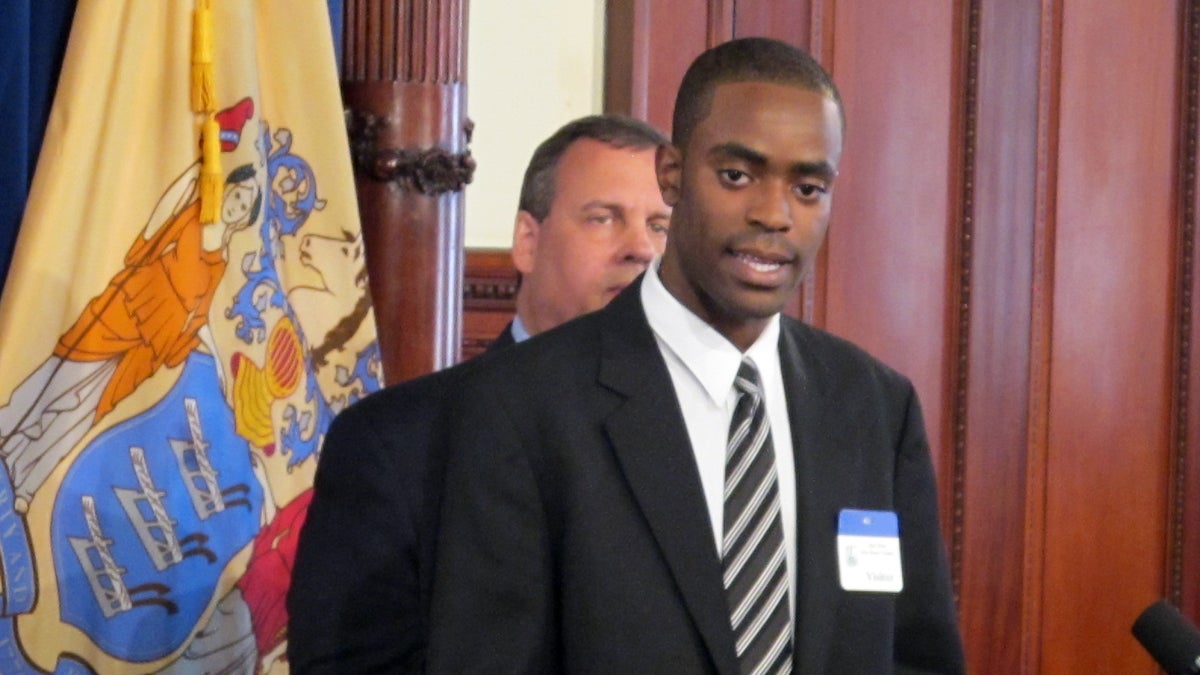  As N.J. Gov. Chris Christie looks on, Jarred Phillips explains why he's participating in the Woodrow Wilson New Jersey Teaching Fellows program. (Phil Gregory/WHYY) 