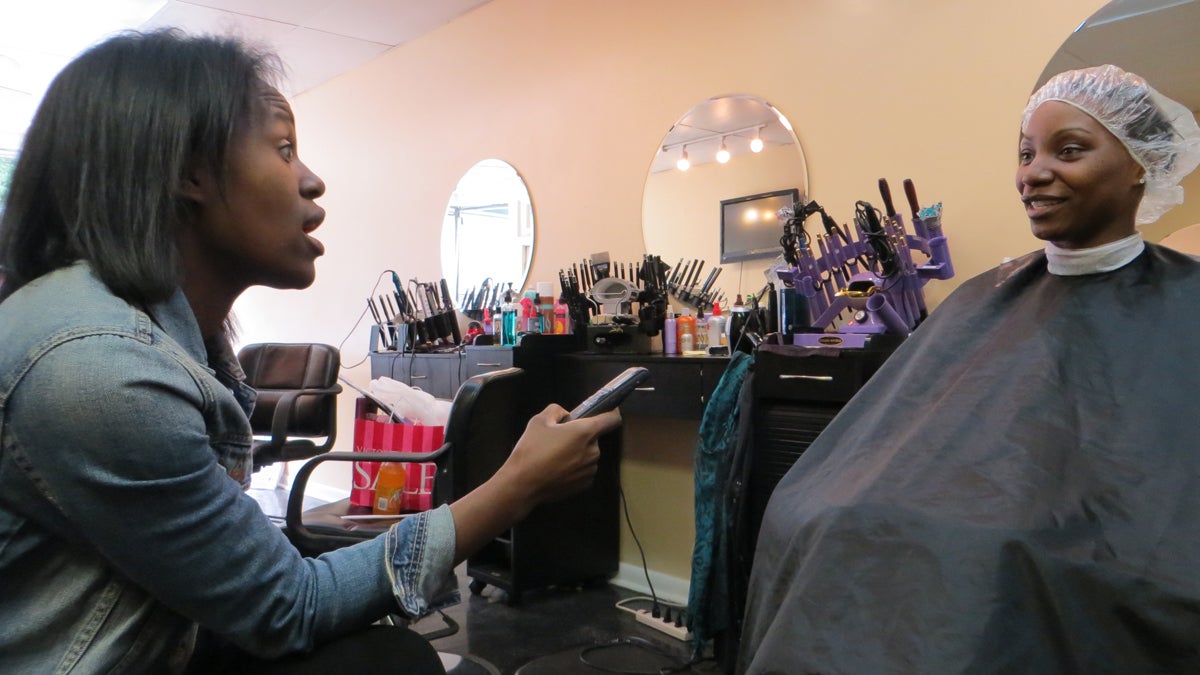  Cardiologist Chileshe Nkonde-Price interviews a client at TraChic Hair Studio in Lansdowne, Pa., as part of her research on heart disease prevention among African American women. (Taunya English/for The Pulse)  