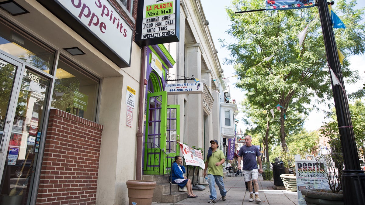  Pedestrians stroll down West Marshall Street, part of the Latino corridor in Norristown, Pa. The collaboration of Norristown police with federal immigration enforcement has resulted in a number of residents being deported. (Lindsay Lazarski/WHYY) 