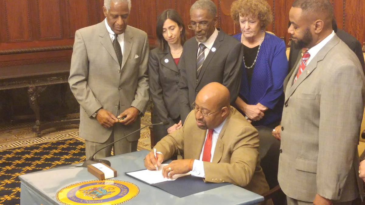  Mayor Michael Nutter signs legislation that strengthens the city's 'ban the box' law. Proponents say it will help Philadelphia combat poverty. (Tom MacDonald/WHYY) 