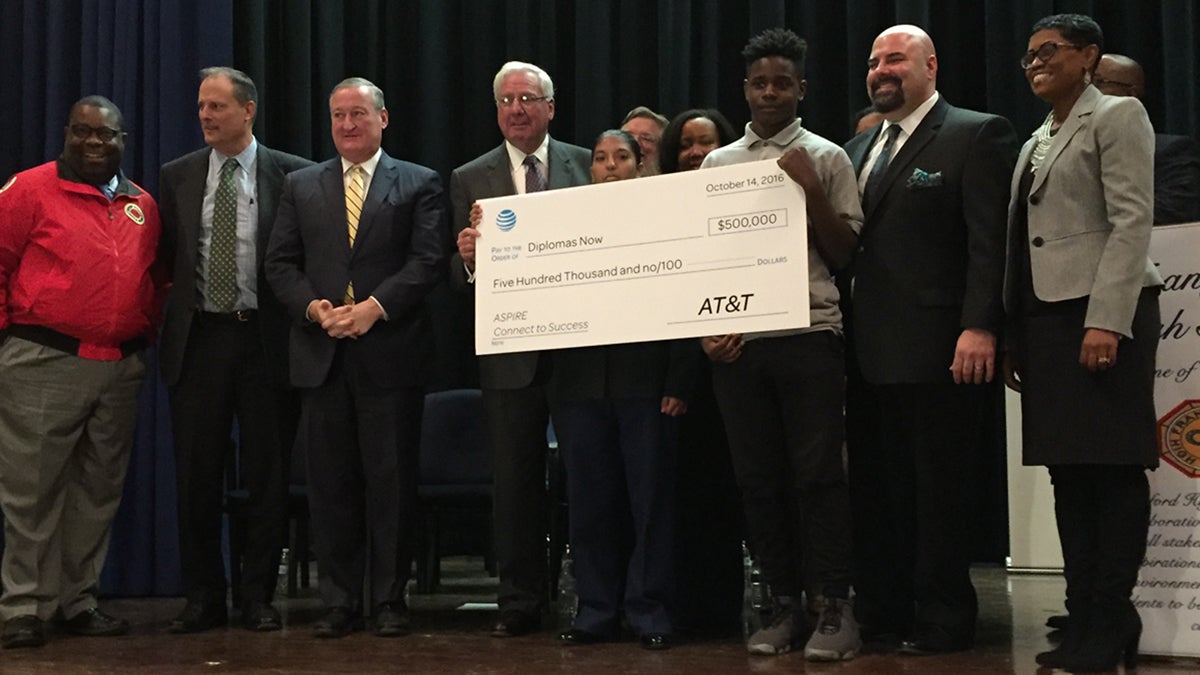 Philadelphia Mayor Jim Kenney (third from left) and others accept a $500