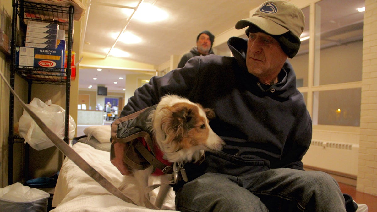  Greg Crockenberg settles in at the Code Blue - and now Code White - shelter at Woodside Church with his dog Sarah. (Emma Lee/WHYY)  