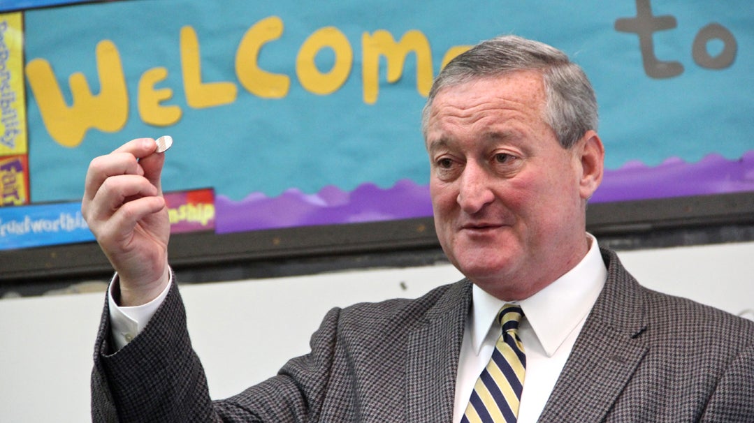  Jim Kenney holds up a SEPTA token, saying that continuing to use  public transit is one of the ways he will keep in touch with his constituency. (Emma Lee/WHYY) 