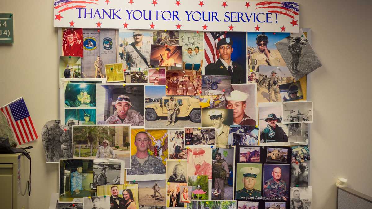  Photos of veterans hang on the wall at the Vets4Warriors suicide prevention hotline center at Rutgers University Behavioral Health Services in Piscataway, New Jersey. (John Abbott/for NewsWorks)  