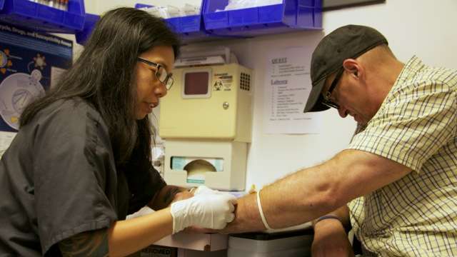  A phlebotomist takes blood for Hepatitis C testing during a patient's weekly visits (Nathaniel Hamilton/for Newsworks) 