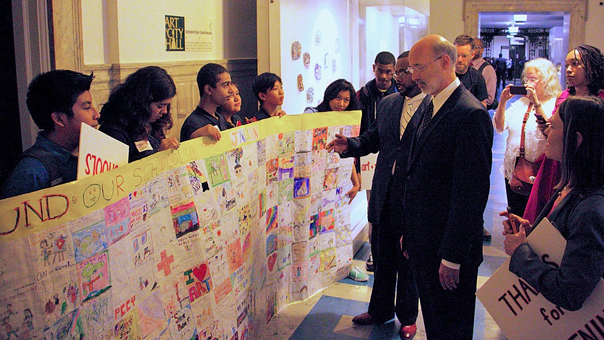  Pa. Gov. Tom Wolf looks over a quilt made by Andrew Jackson Elementary School students in this 2014 file photo (Nathaniel Hamilton/for NewsWorks) 