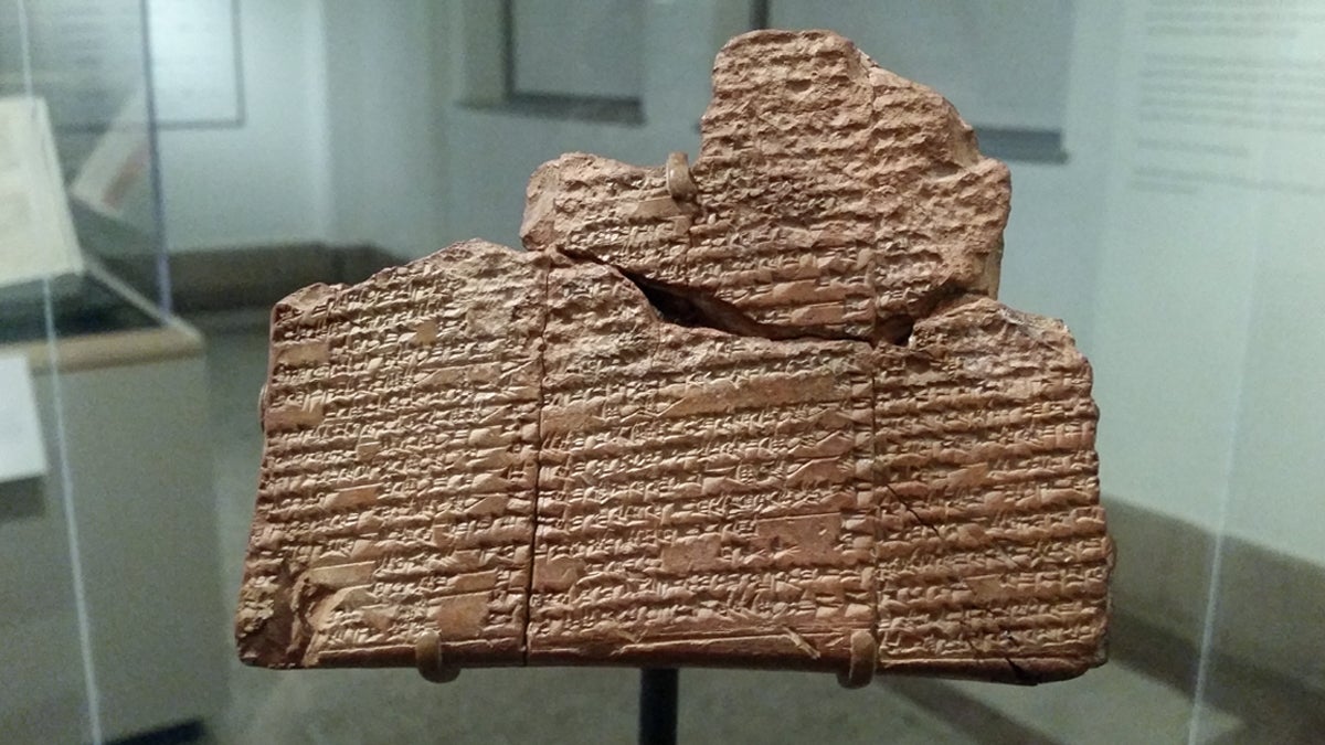  An ancient clay tablet marked with cuneiform, a written language unique to ancient Mesopotamia, on display at Penn Museum (Peter Crimmins/WHYY) 