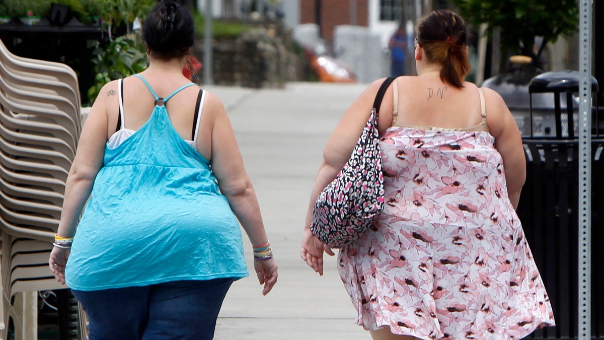 In this  June 17, 2013  photo, two women cross the street in Barre, Vt. In its biggest policy change on weight and health to date, the American Medical Association has recognized obesity as a disease. (AP Photo/Toby Talbot)