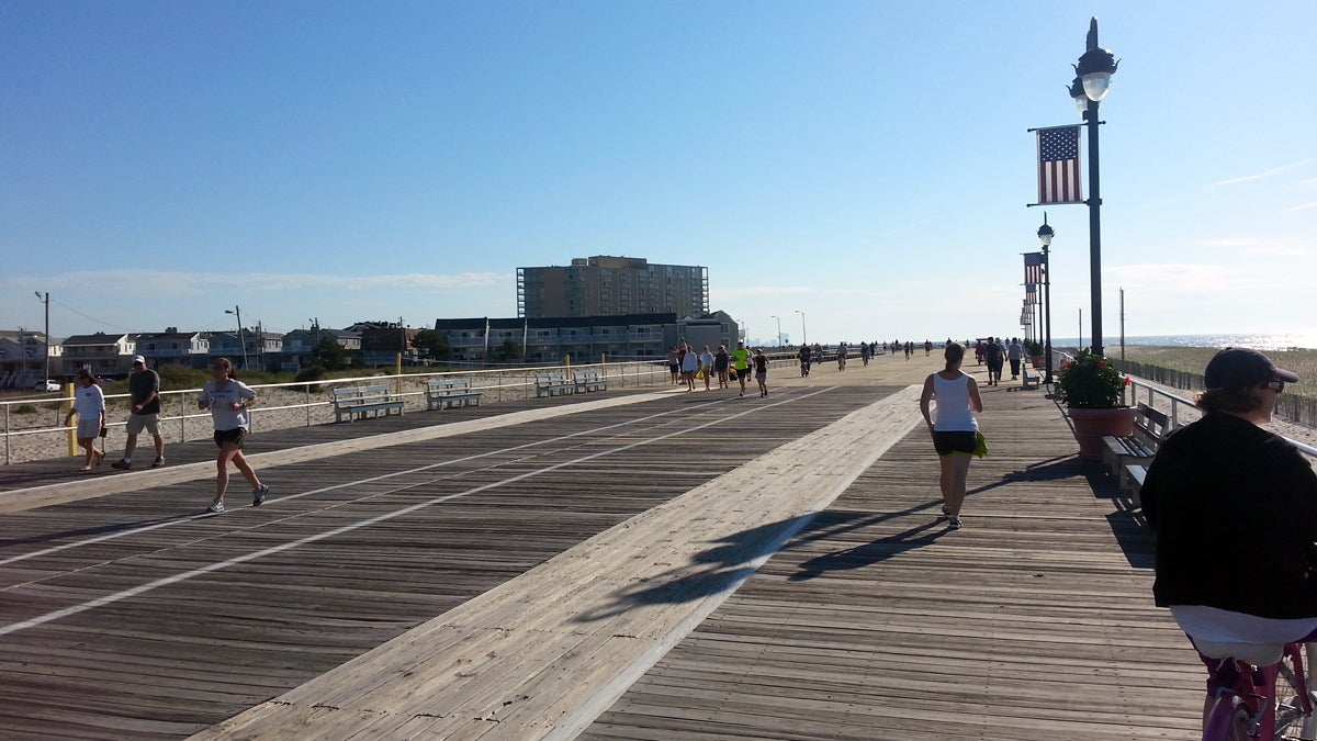 Joggers own the boardwalk at Ocean City, N.J., early on the morning of Memorial Day. (Tom MacDonald/WHYY) 