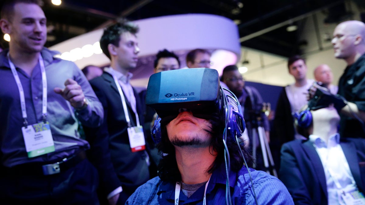  A man is shown playing a video game wearing the Oculus Rift virtual reality headset at the Intel booth at the International Consumer Electronics Show in January. (AP Photo/Jae C. Hong, file) 