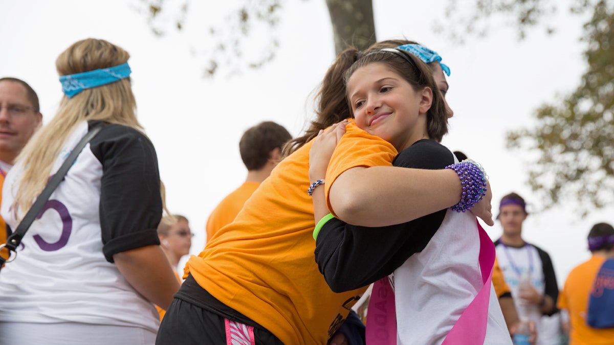  Becca Taylor, 10, of Pittsburgh, Pa. offered hugs to people at the Out of the Darkness walk on Sunday.  Becca was personally touched by suicide when her cousin, Bob Fadzen took his own life.  (Lindsay Lazarski/WHYY) 