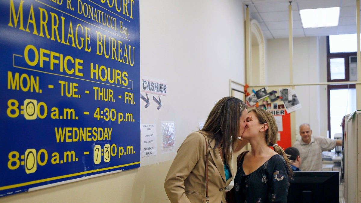  Ashley Wilson (left) and Lindsay Vandermay, both 29, kiss after getting their marriage license at the Philadelphia Marriage Bureau in City Hall in Philadelphia. Pennsylvania's ban on gay marriage was overturned by a federal judge Tuesday. (AP Photo/Matt Slocum) 