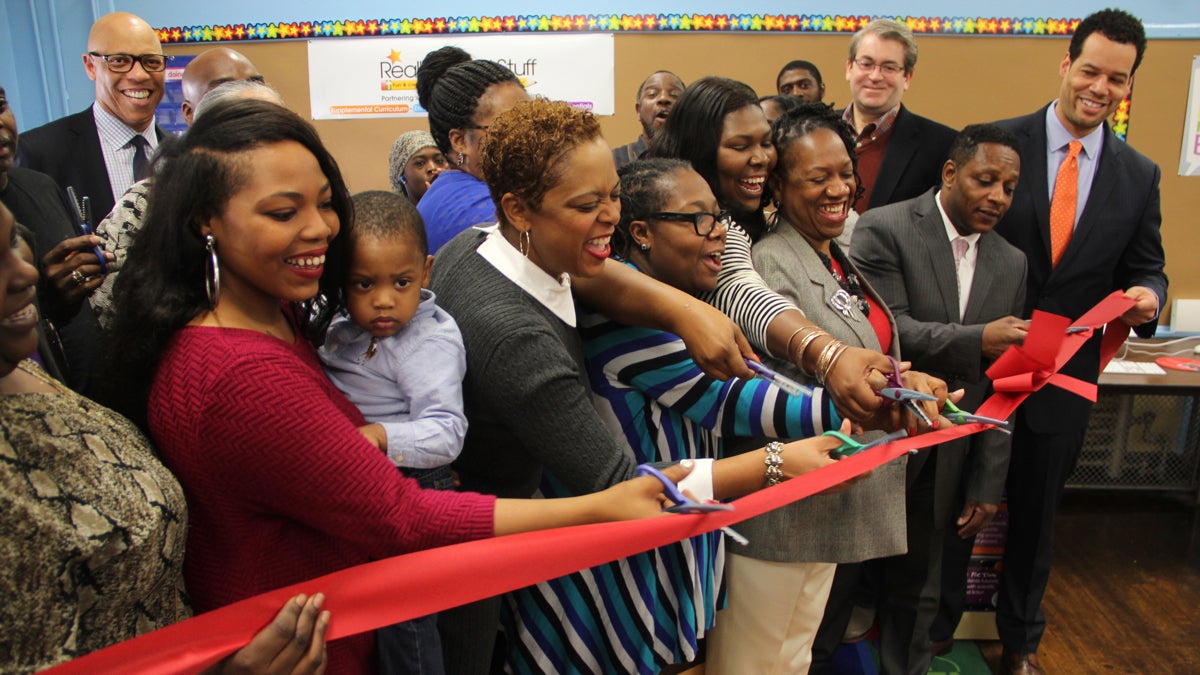Members of the School Reform Commission join parents and school officials in cutting the ribbon to open a new Parent Resource Center at Thomas Pierce Elementary School. (Emma Lee/WHYY)