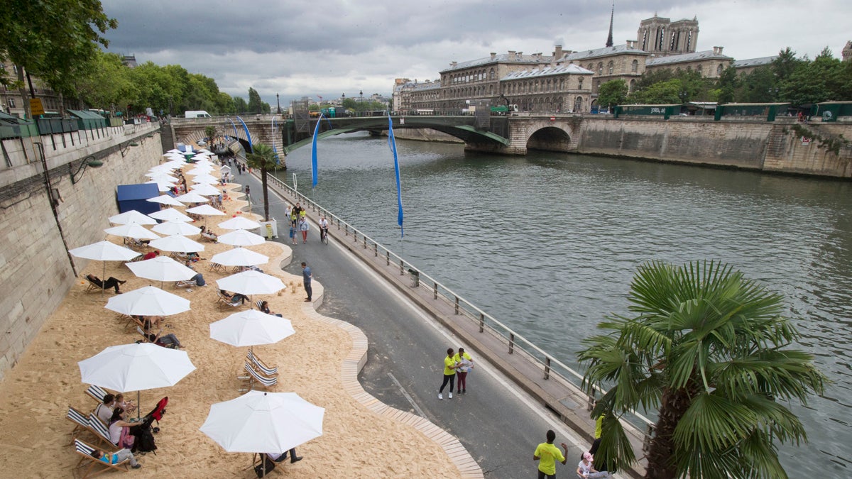  Tourists and Parisians take advantage of Paris Plage, an artificial beach set up on the right bank of the Seine river with palm trees, outdoor showers and hammocks in Paris, France, Monday, July 20, 2015.  (AP Photo/Michel Euler) 