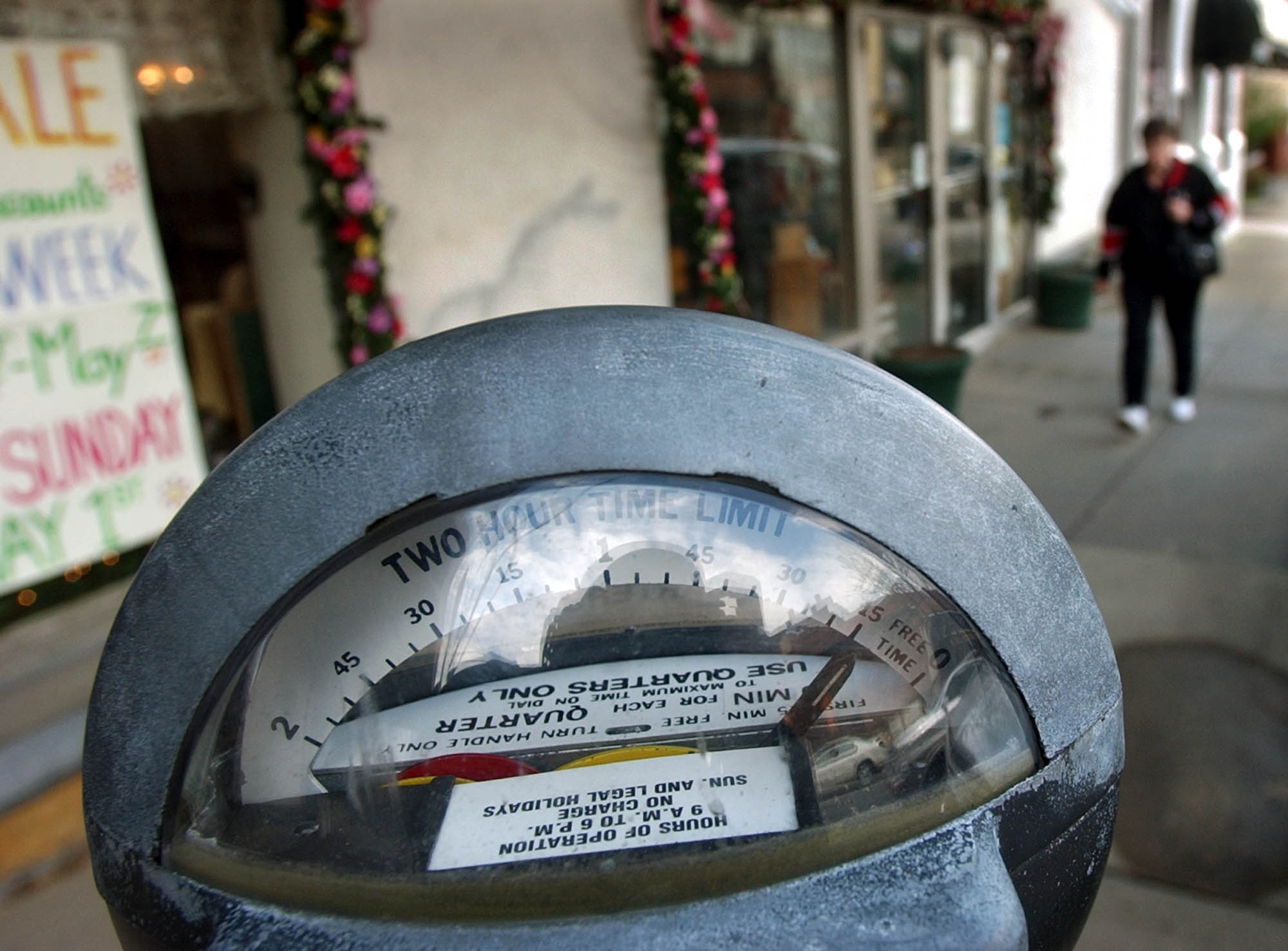 A pedestrian walks towards a parking meter on a side street in downtown Butler, Pa., Wednesday, April 27, 2004. A 1996 law required the state to certify parking meters if a county chose not to. When Butler had a parking ticket contested due to lack of certification, they and many other Pennsylvania municipal governments start calling the state to get their meters certified. (AP Photo/Keith Srakocic)