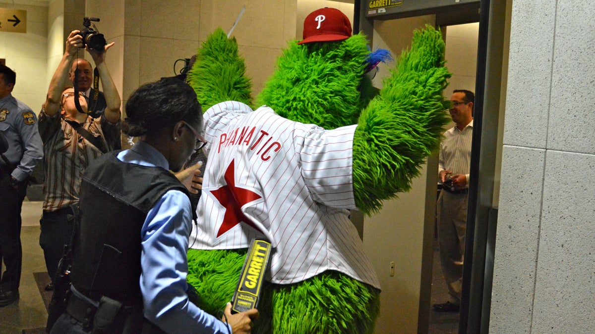 A Philadelphia Sheriff runs the Philly Phanatic through the metal detector at the criminal courts (Tom MacDonald / NewsWorks)