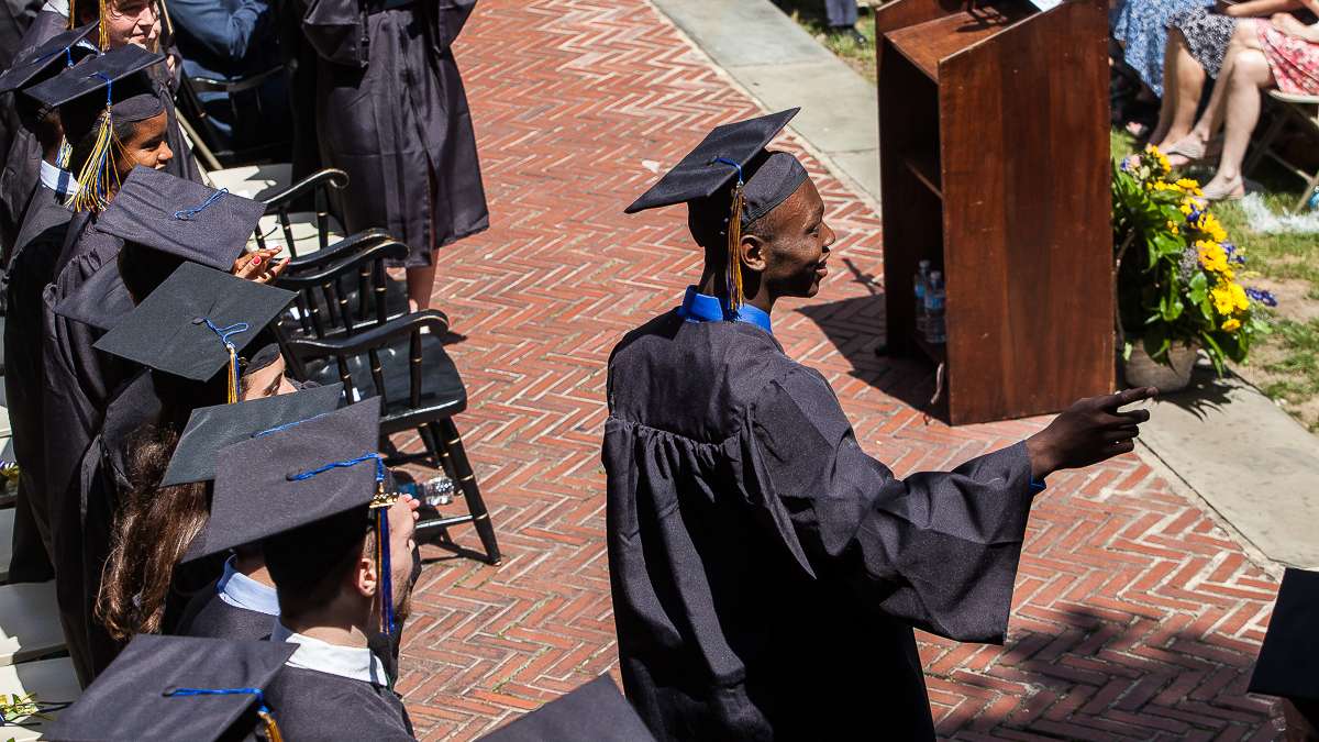  A graduate points to cheering audience members on his way to accept his diploma during Penn Charter's 2014 graduation ceremony. (Brad Larrison/for NewsWorks) 