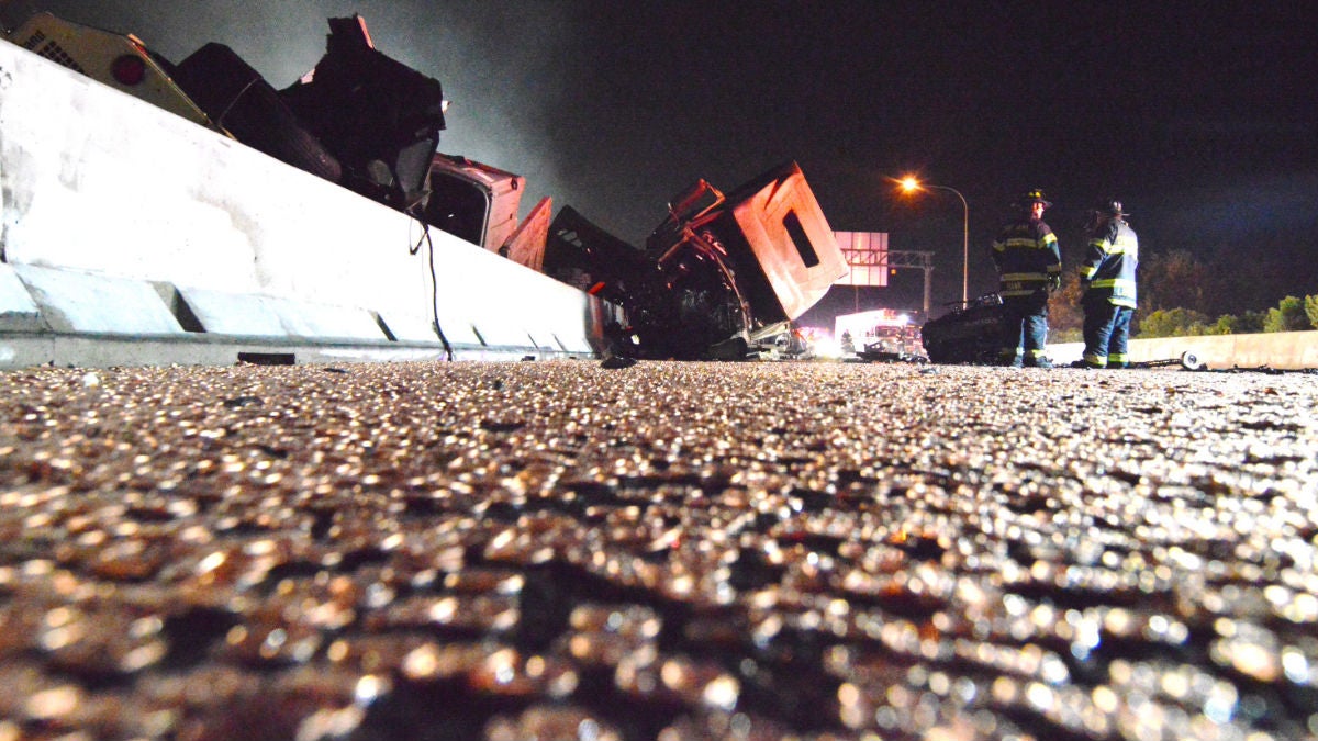 Thousands of blank pennies cover I-95 following an accident early Thursday morning. (John Jankowski/for NewsWorks)