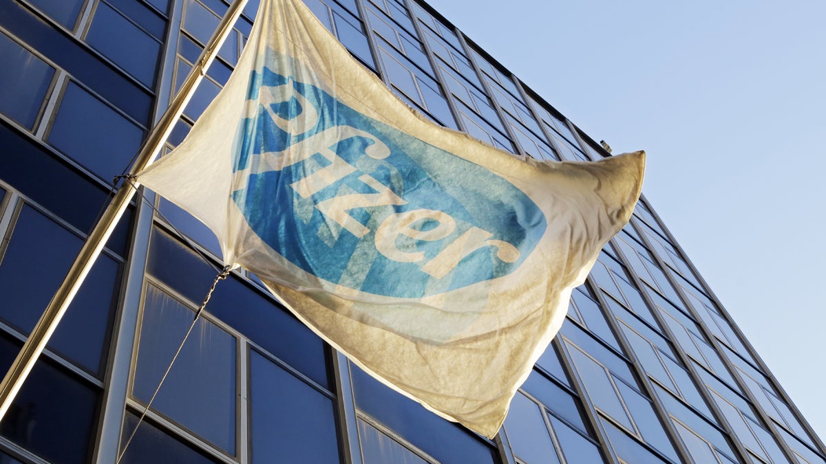 The Pfizer flag flies in front of world headquarters in New York. (AP Photo/Mark Lennihan