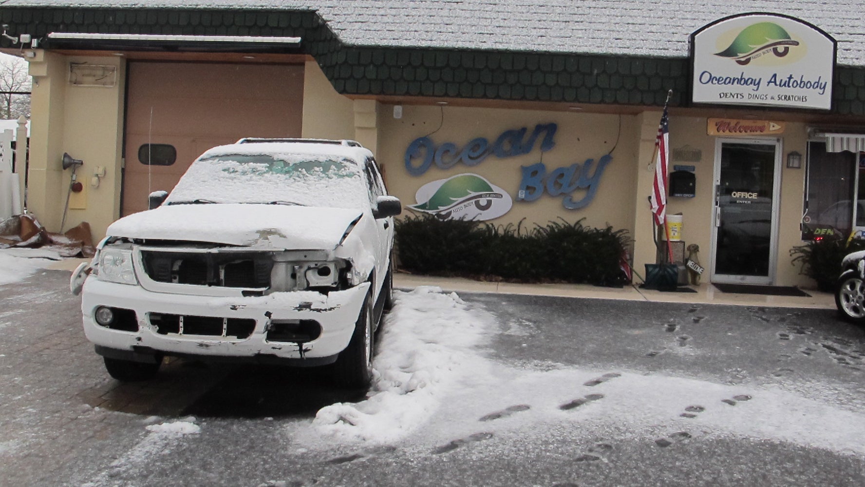  A vehicle that was damaged during the snowstorms awaits reports at Oceanbay Autobody in Point Pleasant, New Jersey (Phil Gregory/NewsWorks Photo) 