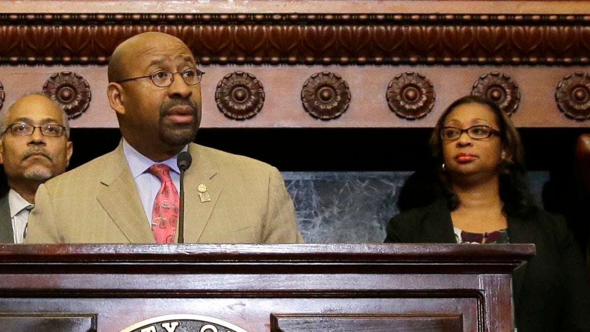 Desiree Peterkin Bell (right) stands with Philadelphia Mayor Michael Nutter during a news conference Tuesday
