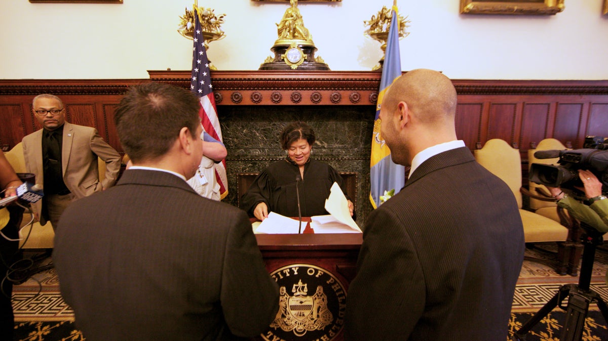  Oscar Cabrera and Chris DiCapua stand in front of a judge in the Philadelphia mayor’s reception room about to be married. (Nathaniel Hamilton/for NewsWorks) 