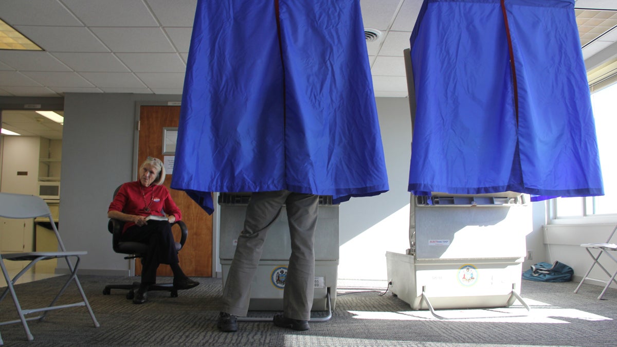 A voter in Philadelphia's 5th District casts her ballot in the solarium at Hopkinson House. (Emma Lee/WHYY)