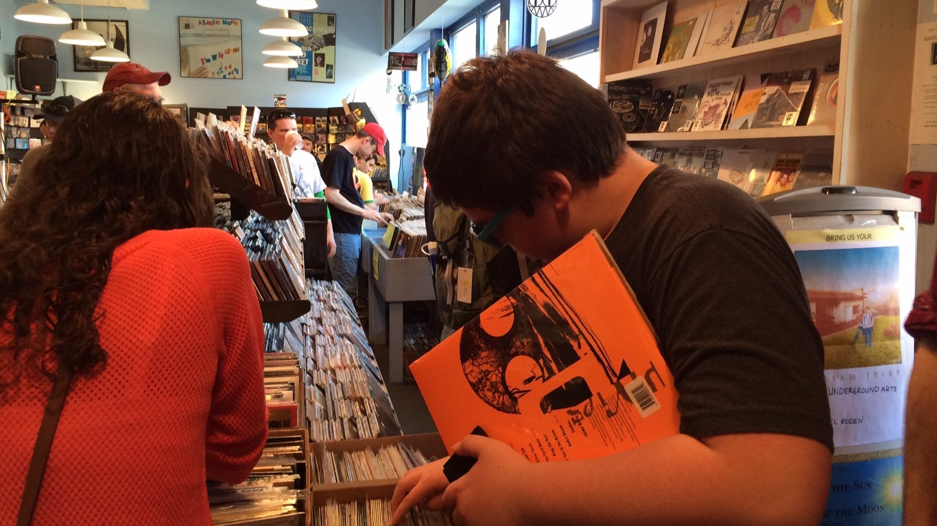  Having secured the latest Pixies release, the author's son, Jack, combs through the vinyl selections at Main Street Music. (Amy Z. Quinn/for NewsWorks) 