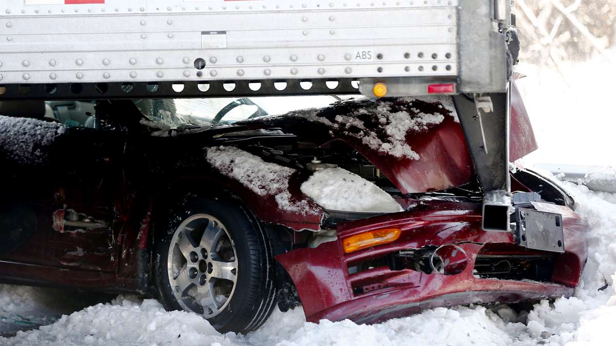  A car is wedged under a semi-trailer in a huge pile-up on the Pennsylvania Turnpike in Bensalem, Pa. (Matt Rourke/AP Photo) 