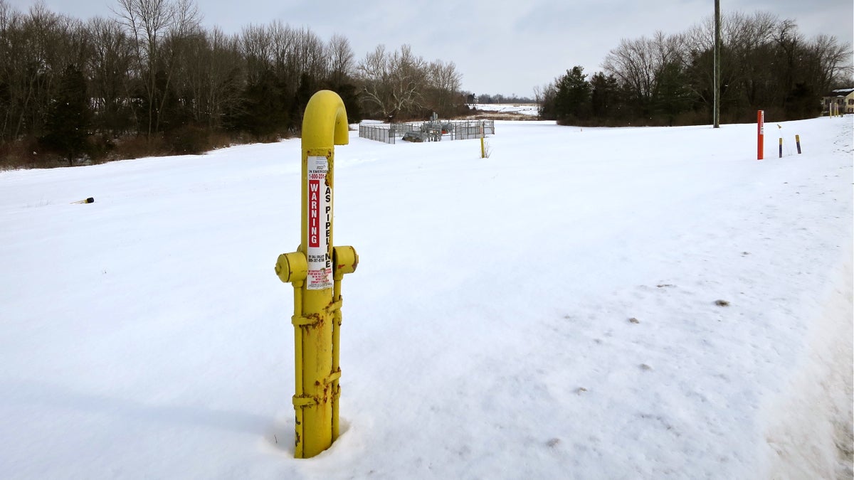  A marker shows the path of the Texas Eastern Pipeline as it runs under a field in Lambertville, New Jersey. It is one of several natural gas pipelines buried under farms, forests, backyards and waterways in the region. (Katie Colaneri/WHYY) 