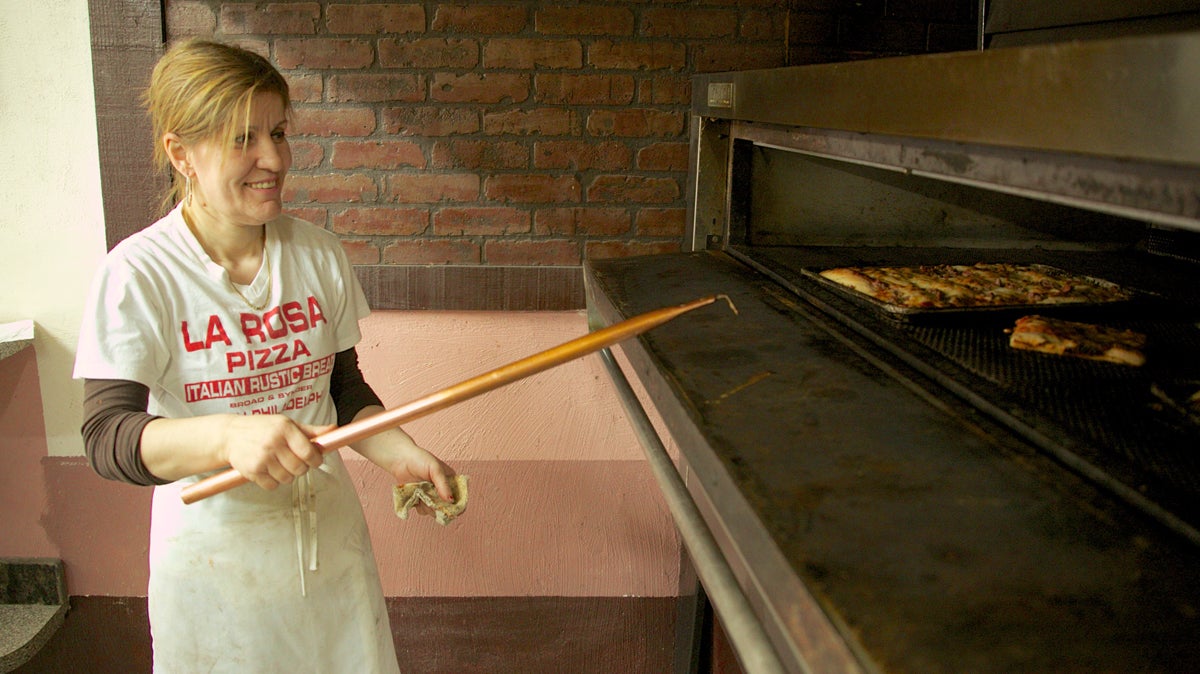  Anastasia Tanellari works the pizza oven at La Rosa Pizza. (Nathaniel Hamilton/for NewsWorks) 