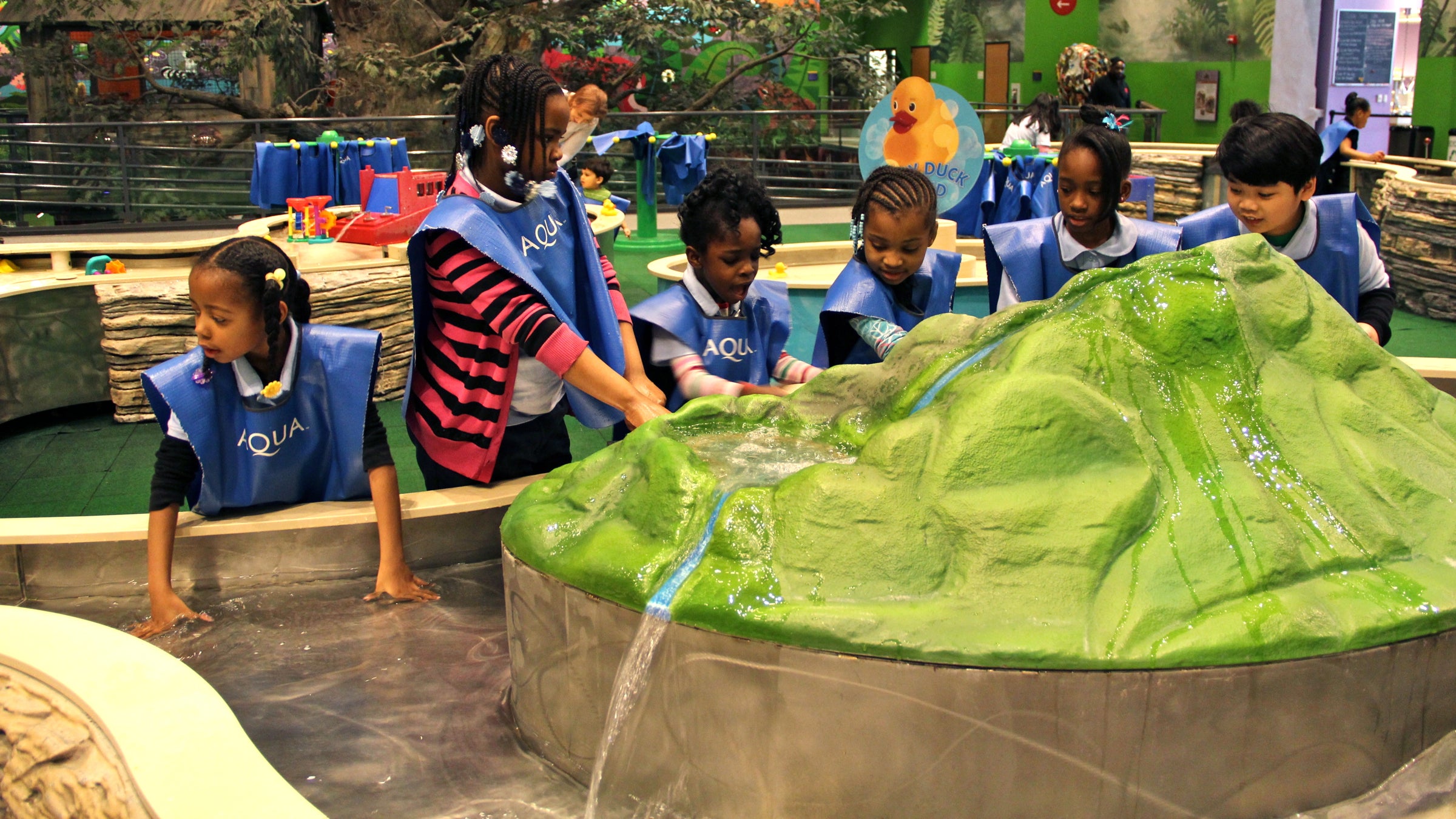 Children playing in the water play area at Philadelphia's Please Touch Museum