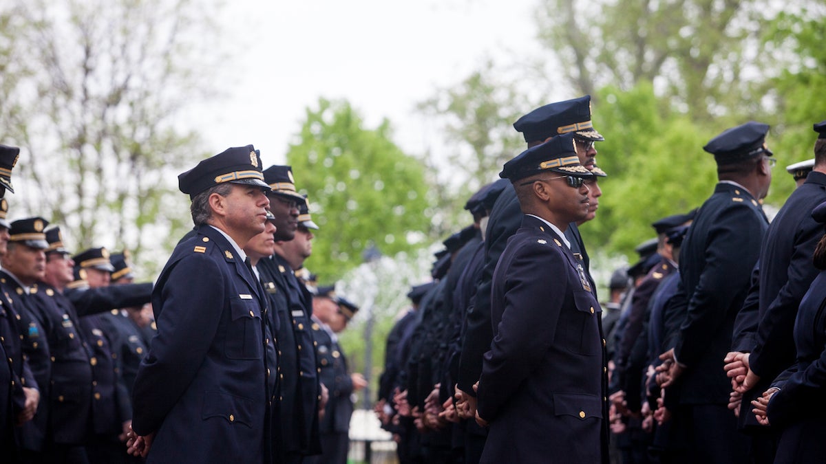 Philadelphia Police Officers stand at the Living Flame Memorial for fallen officers and fire fighthers in Franklin Square
