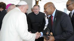  In this picture made available by the Vatican newspaper L'Osservatore Romano, Pope Francis shakes hands with Mayor of Philadelphia Michael Nutter, at the Vatican, Wednesday, March 26, 2014. (AP Photo/L'Osservatore Romano)  